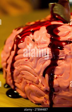 Gâteau au cerveau givré rose avec un filet de sang en gros plan chaud et léger Banque D'Images