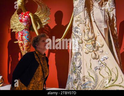 Auckland, Nouvelle-Zélande. 8 décembre 2023. Une personne regarde les créations du couturier chinois Guo Pei à Auckland, Nouvelle-Zélande, le 8 décembre 2023. L'exposition « Fashion, Art, Fantasy » de samedi présentera plus de 60 vêtements saisissants de la carrière de Guo Pei, longue de deux décennies, invitant les Néo-Zélandais à s'immerger dans la grandeur de sa couture artistique. POUR ALLER AVEC 'Feature : l'exposition d'art couture du designer chinois Guo Pei enchante Auckland' crédit : Guo Lei/Xinhua/Alamy Live News Banque D'Images