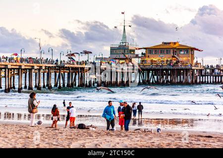 Touristes prenant des photos sur Santa Monica Beach, avec Santa Monica Pier en arrière-plan, après-midi d'été dans le sud de la Californie Banque D'Images