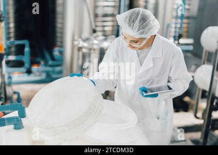 travailleur du personnel d'hygiène dans les aliments et les boissons usine propre. les femmes qui travaillent dans le contrôle de la qualité de l'industrie des usines d'eau. Banque D'Images