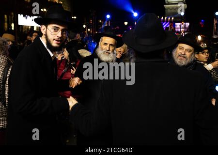 Paris, France. 11 décembre 2023. Hommes juifs vus danser pendant les festivités de Hanukkah à la place de Bastille. Le cinquième jour des festivités de Hanukkah à Paris a eu lieu sur la place de Bastille. Hanukkah est une fête juive qui commémore la récupération de Jérusalem. Le festival est observé en allumant les bougies d'un candélabre à neuf branches, communément appelé menorah ou hanukkiah. (Photo Telmo Pinto/SOPA Images/Sipa USA) crédit : SIPA USA/Alamy Live News Banque D'Images