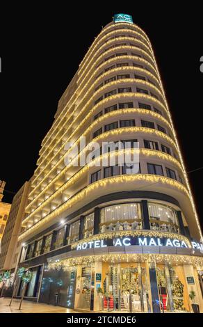 Malaga, Espagne - 25 novembre 2023 : AC Hotel by Marriott Malaga Palacio (Palace) décoré à illuminé à Noël la nuit Banque D'Images