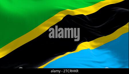 Vue rapprochée du drapeau national de la Tanzanie qui agite. Triangles verts et bleus avec une bande diagonale noire et des bords jaunes. Arrière-plan texturé en tissu. Banque D'Images