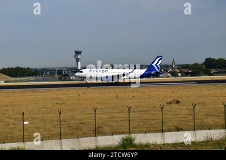 Aegean Airlines A320 atterrit sur la piste 25L avec de la fumée blanche provenant des pneus des trains d'atterrissage à l'aéroport international de Bruxelles Banque D'Images