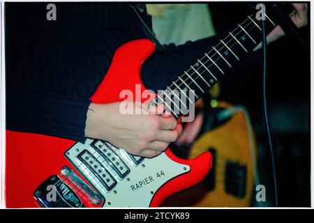 TRISH KEENAN, DIFFUSION, 1996 : a very Young Trish Keenan (1968-2011) la chanteuse du groupe British Electronic Broadcast jouant une guitare Wilson Rapier 44 en soutien à Stereolab Cardiff University, pays de Galles, Royaume-Uni le 21 novembre 1996. Cette photo a été prise au début de la tournée de carrière acclamée par la critique avec leur premier single et leur premier EP, The Book Lovers. Malheureusement, Trish meurt inopinément d'une pneumonie après avoir contracté la grippe porcine en janvier 2011 alors qu'elle était en tournée en Australie. Photo : Rob Watkins Banque D'Images