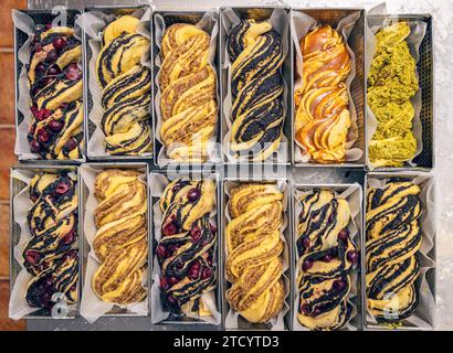 Beaucoup de babka de pain sucré cru avec différentes garnitures dans un moule prêt à cuire Banque D'Images