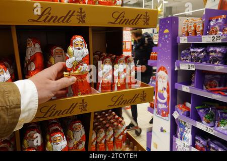 Shopper sélectionnant des cadeaux en chocolat de Noël Banque D'Images