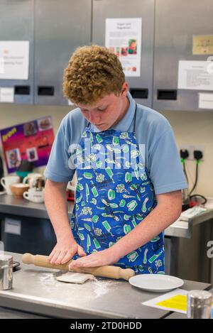 Étudiants qui étudient la technologie alimentaire pour GCSE et travaillent à la préparation des aliments dans la cuisine. Banque D'Images
