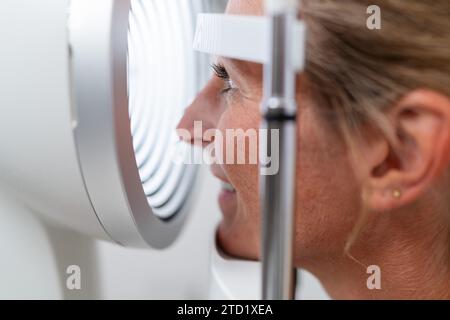 Gros plan d'un patient soumis à un examen oculaire avec un kératographe ou un phoroptre à la clinique ophtalmologique. Gros plan. Santé et médicis Banque D'Images