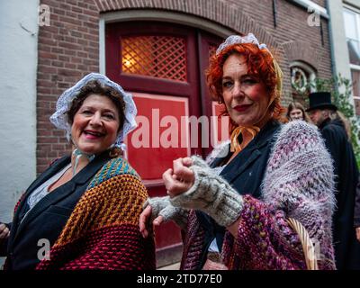 Deventer, pays-Bas . 16 décembre 2023. Deux femmes portant des costumes victoriens posent pour la caméra. Chaque année, vers cette date, le monde du 19e siècle de l'écrivain anglais Charles Dickens revit dans la belle ville hollandaise de Deventer. Plus de 950 personnages des célèbres livres de Dickens remontent à la vie. Riches dames et messieurs avec des chapeaux de haut défilé dans les rues.le paysage du festival se compose de bâtiments historiques, arbres de Noël, et des milliers de petites lumières. Crédit : SOPA Images Limited/Alamy Live News Banque D'Images