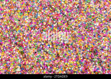 Vibrant Confetti Celebration : texture de fond de fête colorée pour les événements festifs, deux ours en gomme cachés et faisant dans un lit de confettis Banque D'Images