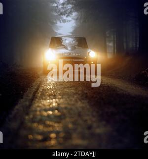 1970 Jaguar E-type Series 3, SWK582H, prototype 2+2 V-12, sur piste boisée isolée dans un environnement forestier atmosphérique, tôt le matin ou le soir. Banque D'Images