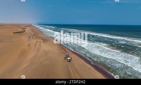 Voitures roulant sur la crête des dunes de sable le long de l'Atlantique, Namibe (Namib) désert, Iona National Park, Namibe, Angola, Afrique Banque D'Images