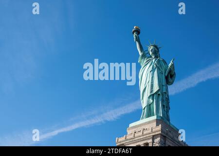 Magnifique vue vers le haut de la Statue de la liberté, symbolisant la liberté et la démocratie contre un ciel bleu clair Banque D'Images