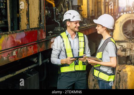 Ingénieur homme d'équipe flirter les femmes tout en travaillant heureux ensemble profiter de l'ami se détendre souriant parler dans l'usine de l'industrie. Banque D'Images