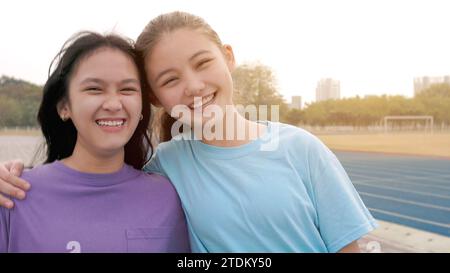 heureux jeunes filles d'école debout ensemble souriant et regardant la caméra Banque D'Images