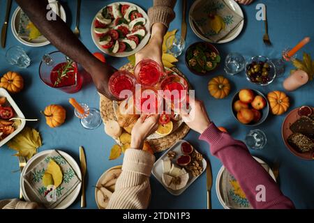 Vue de dessus d'un groupe inconnu de personnes levant des verres ensemble buvant à Happy Thanksgiving Banque D'Images