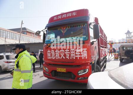 (231220) -- LINXIA, 20 déc. 2023 (Xinhua) -- Un camion chargé de matériel de secours d'urgence arrive sur un site de relocalisation temporaire dans le village de Dahe, dans le comté de Jishan, dans la province du Gansu, au nord-ouest de la Chine, le 20 décembre 2023. Des opérations de sauvetage et de secours sont en cours dans un climat de froid intense alors qu'un tremblement de terre de magnitude 6,2 a tué 113 personnes et blessé 782 autres dans la province du Gansu, dans le nord-ouest de la Chine, selon une conférence de presse donnée mercredi. Au total, 87 076 personnes de 20 457 ménages ont été temporairement réinstallées dans des lieux sûrs. Matériel de secours d'urgence tels que tentes, couettes, lits pliants Banque D'Images