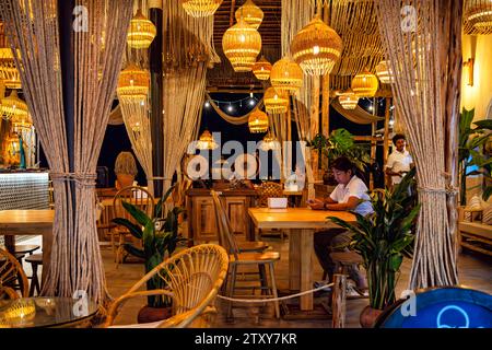 Intérieur de restaurant thaïlandais avec clients, personnel et meubles en osier, Fishermans Village, Ko Samui, Thaïlande Banque D'Images