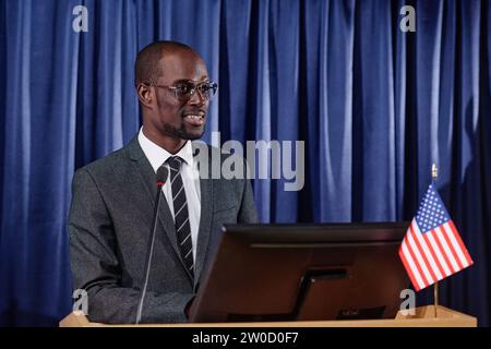 Politicien afro-américain en costume donnant son discours à une conférence d'affaires Banque D'Images