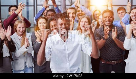 un grand groupe international de personnes heureuses applaudit ensemble Banque D'Images