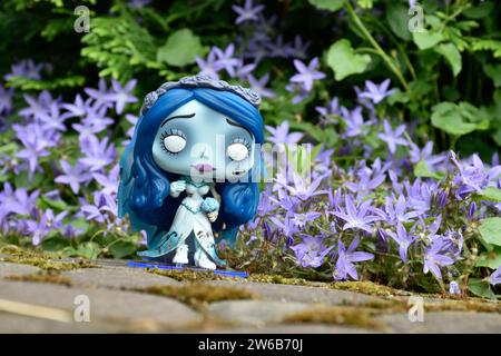 Funko Pop figure d'action d'Emily du film d'animation gothique sombre de fantaisie Corpse bride. Fleurs bleues, mousse, route de pierre, jardin mystérieux, mariage. Banque D'Images