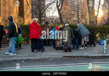 Les clients à l'extérieur de l'église communautaire Manor à Chelsea à New York lors de la distribution de nourriture de leur garde-manger le samedi 16 décembre 2023. (© Richard B. Levine) Banque D'Images