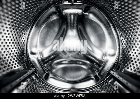 Lave-linge sèche-linge vue de l'intérieur. Tambour de lave-linge, vue de l'intérieur. Tambour métallique d'une machine à laver. Fond abstrait de la maison. À l'intérieur de Banque D'Images