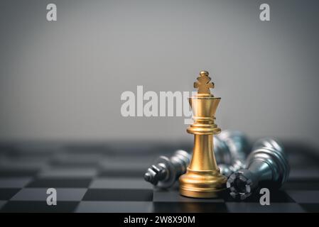 King Chess se dresse au milieu des pièces tombées, symbolisant le leadership, le travail d'équipe et la victoire sur la compétition. Banque D'Images