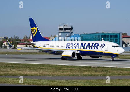 Le Boeing 737-800 Ryanair de la compagnie aérienne irlandaise low-cost décolle de l'aéroport de Lviv, avec la tour ATC en arrière-plan Banque D'Images