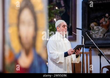 Berlin, Allemagne. 24 décembre 2023. L'Imam Osman Örs parle lors d'un service de Noël de la « Maison de l'un » interconfessionnelle avec des invités juifs et musulmans à Saint Église de Marie sur Alexanderplatz. Crédit : Christoph Soeder/dpa/Alamy Live News Banque D'Images