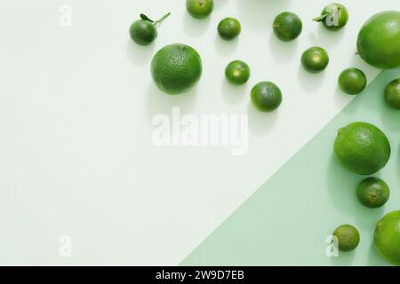 Sur le fond vert, la couleur verte des limes et des kumquats sont décorés. Fond créatif avec espace vide pour la conception et l'espace de copie. Vue de dessus, fl Banque D'Images