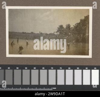 Pêcheurs debout dans les eaux peu profondes des Indes orientales néerlandaises, c. 1920 - c. 1930 photographie partie de l'album photo de la famille Kleiterp-Vermeulen avec des enregistrements des Indes orientales néerlandaises. Dutch East Indies, le journal. Support photographique gélatine argentique pêcheur Dutch East Indies, le Banque D'Images