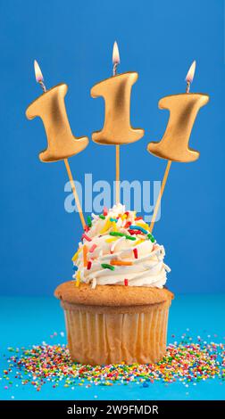 Bougie numéro 111 - anniversaire de gâteau sur fond bleu Banque D'Images