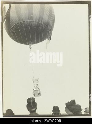 The Third Gordon Bennett Balloon Race, 1908 photographie montgolfière avec un homme dans le panier. Au premier plan têtes de spectateurs. Schmargendorf baryta papier gélatine argentique ballon imprimé (aviation). (voler un) ballon à gaz. Vol en montgolfière (sport) Schmargendorf Banque D'Images