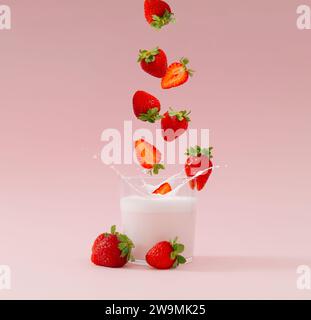 Disposition créative faite de fraises tombant dans une tasse en verre de boisson au lait avec goût de fraise sur fond rose pastel. Concept de smoothie minimal. Banque D'Images