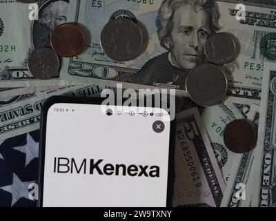 Dans cette illustration photo, un Kenexa, un logo IBM Company vu affiché sur un smartphone avec des billets et des pièces de monnaie en dollars des États-Unis en arrière-plan. Banque D'Images