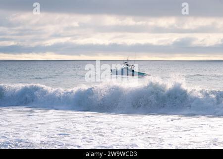 Un bateau de sauveteur patrouille la côte sud de la Californie pendant les conditions de surf à la plage de point Dume à Malibu, Californie, États-Unis Banque D'Images