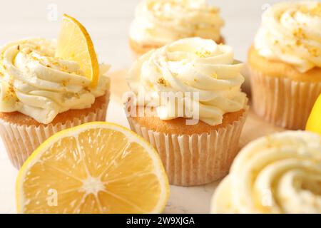 Délicieux cupcakes à la crème et au zeste de citron à bord, gros plan Banque D'Images