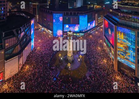 CHONGQING, CHINE - 31 DÉCEMBRE 2023 - Un grand nombre de personnes se rassemblent sous le monument Jiefang pour écouter la cloche du nouvel an et libérer Wish bal Banque D'Images