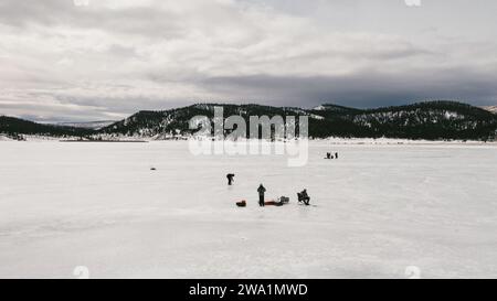 Pêcheurs sur le lac gelé dans la vallée de montagne pêche sur glace Banque D'Images