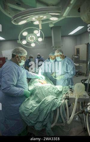 Khan Yunis, Gaza. 31 décembre 2023. Le chirurgien américain Imad (à droite) opère un patient dans une salle d’opération chirurgicale à l’hôpital européen de Khan Yunis, dans le sud de la bande de Gaza, le lundi 1 janvier 2024. Le chirurgien Imad, accompagné d’un groupe de médecins, est arrivé à Gaza depuis le poste frontière de Rafah avec l’Égypte, pour effectuer des opérations chirurgicales sur les Palestiniens blessés pendant la guerre. Photo par Ismael Mohamad/UPI crédit : UPI/Alamy Live News Banque D'Images