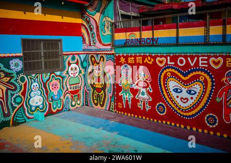 Taichung, Chine. 02 janvier 2024. Les gens interagissent avec le Street art vibrant au Rainbow Village à Taichung, Taiwan le 02/01/2024 les peintures murales colorées, créées par Huang Yung-Fu, un ancien soldat connu sous le nom de "Rainbow Grandpa", ont transformé un village dépendant de l'armée en une destination artistique célèbre, le sauver de la démolition et capturer l'esprit de la communauté avec ses peintures fantaisistes. Le village est devenu une attraction touristique populaire et sert en même temps comme un symbole significatif du patrimoine local et de la résistance créative par Wiktor Dabkowski crédit : dpa / Alamy Live News Banque D'Images