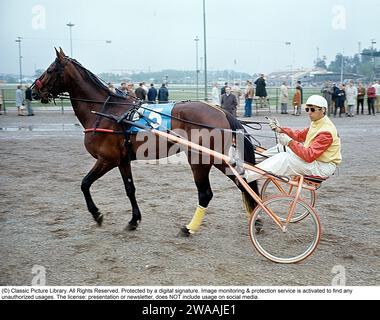 Olle Elfstrand. Entraîneur de trot suédois et jockey. Au cours de sa carrière, il a réussi l'exploit de remporter plus de 2000 courses en tant que jockey. Ici dans le sulky avec le cheval de Trotting Lyon qu'il a entraîné pendant la majeure partie de sa carrière de coureur. Lyon a été sélectionné comme cheval de l'année à trois reprises et est devenu le premier cheval de trot d'origine suédoise à atteindre un million de couronnes suédoises en prix. 1972 réf. BV9 Banque D'Images