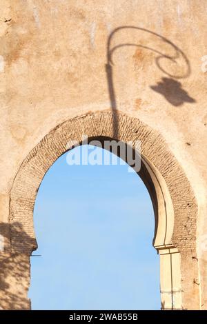 Ombre d'un réverbère sur une arche du mur de la forteresse de Fès, Maroc. Banque D'Images