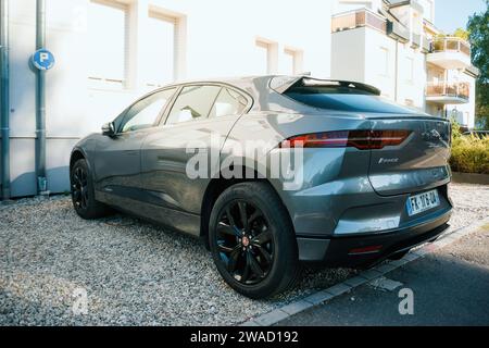 Paris, France - 12 août 2022 : un élégant véhicule électrique Jaguar I-PACE stationné sur un terrain de gravier, présentant un design moderne et un transport écologique. Banque D'Images