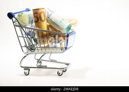 panier rempli de billets en euros enroulés, isolés sur fond blanc Banque D'Images