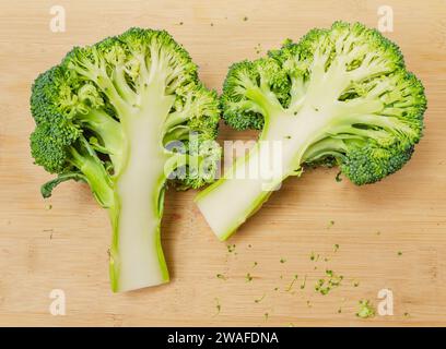 Deux moitiés de brocoli vert frais sur planche de bois. Un légume appétissant pour une alimentation saine. Banque D'Images