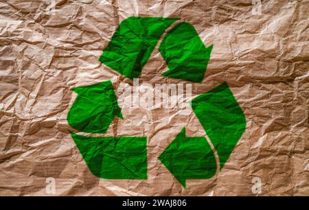 Papier recyclé avec beaucoup de texture et de ton brun avec le logo Recycle imprimé sur le papier. Concept de recyclage. Banque D'Images