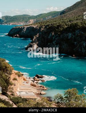 Une vue panoramique sur la plage Cala d'en Serra avec des cabanes de pêcheurs à Ibiza, Espagne Banque D'Images